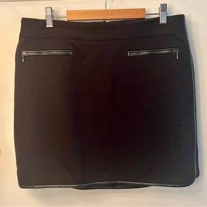 White House Black Market Black Skirt with vegan leather trim. Size 10, stretchy